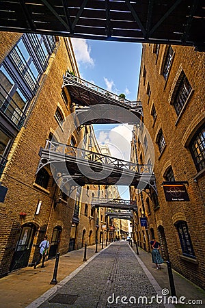 Shad Thames in London, UK. Historic Shad Thames is an old cobbled street known for its restored overhead bridges and walkways Editorial Stock Photo