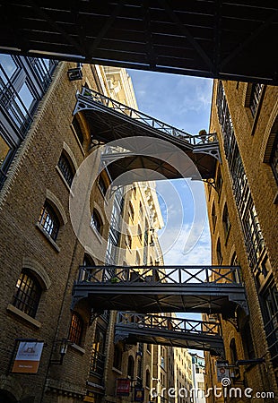 Shad Thames in London, UK. Historic Shad Thames is an old cobbled street known for it`s restored overhead bridges and walkways Editorial Stock Photo