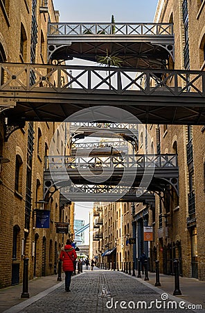 Shad Thames in London, UK. Historic Shad Thames is an old cobbled street known for it`s restored overhead bridges and walkways Editorial Stock Photo