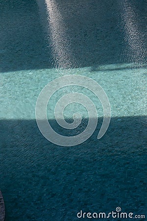 Shade and Shadow on the blue swimming pool Stock Photo