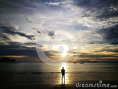 shade and shadow of single man on the beach with sunset in Krabi Thailand Editorial Stock Photo