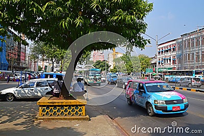 Shade under a big tree with vehicles on Sule Pagoda Road in Yangon, Myanmar Editorial Stock Photo