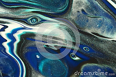 Classic blue, glittery teal, white, and black blend to create a snowy effect in this abstract background. Stock Photo