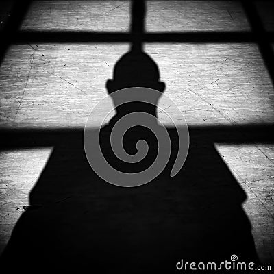 Shadow of an adult person on the floor with daylight coming through the windows Stock Photo