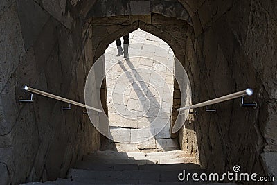 Shadow in the arch doorway,stairs down the entrance through the arch, steps Stock Photo