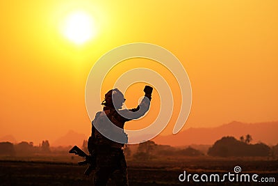 Shadow of the battle of soldiers on the battlefield patrolling at sunset Stock Photo