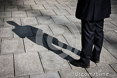 Shadow of a businessman standing Stock Photo