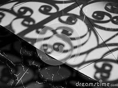 Shadow of curved steel window decoration shading on marble floor Stock Photo