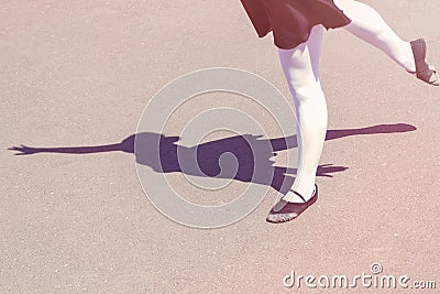 Shadow of dancer girl which makes dance moves in a bathing suit for dancing and ballet shoes Stock Photo