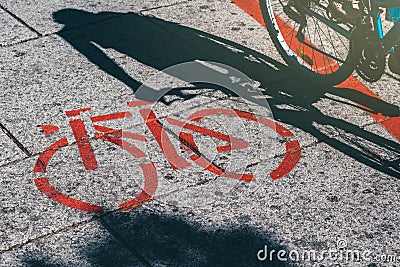 Shadow of female biker and bicycle route road marking Stock Photo