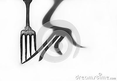 The shadow of the fork. Black and white photo. Stock Photo