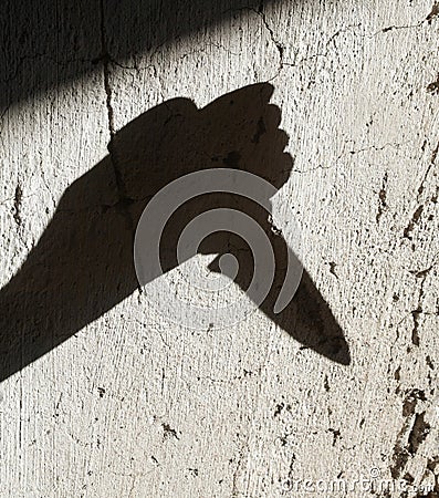 Shadow of the hand holding a knife Stock Photo