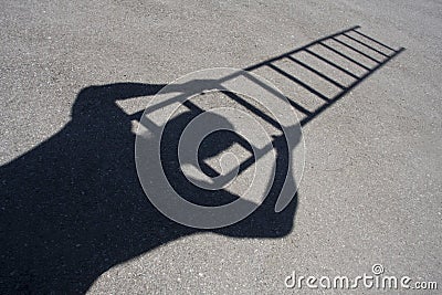 Shadow of man climbing ladder Stock Photo