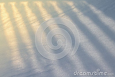 Shadow from an openwork fence, falling on the snow as a background or a backdrop Stock Photo