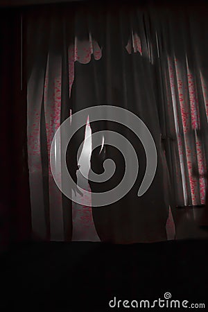 Shadow of a person behind a curtain Stock Photo