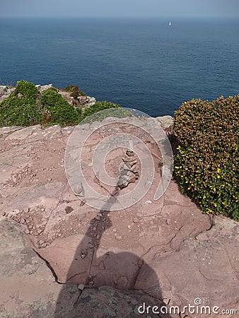 Shadow of photographer touches a pile of stones Stock Photo