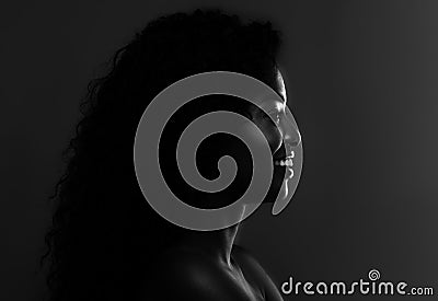 In The Shadow. Profile Of Black Attractive Female Over Dark Background, BW Stock Photo