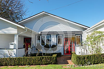 Shadow reflects roofline of white colonial houe from street Editorial Stock Photo