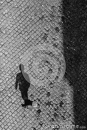 Shadow of senior man on cobble stone Editorial Stock Photo