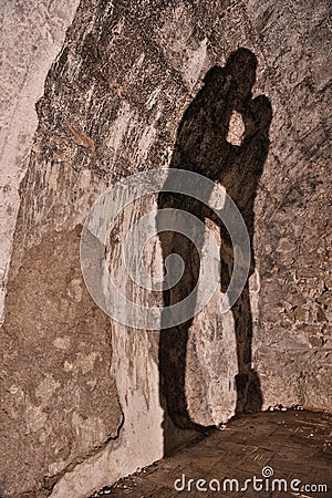 Shadow on stone wall of couple kissing Stock Photo