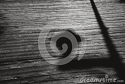 Shadow of street light on a wooden boardwalk Stock Photo