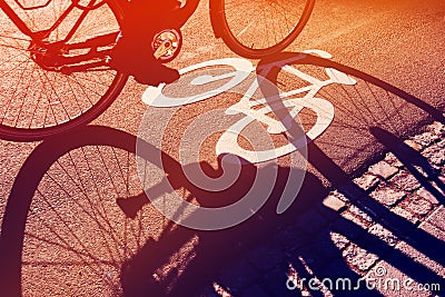 Shadow of unrecognizable cyclist on bicycle lane Stock Photo