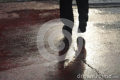 Shadow of unrecognizable person at pedestrian crossing - Back li Stock Photo