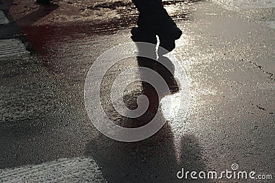 Shadow of unrecognizable person at pedestrian crossing - Back li Stock Photo