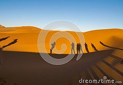 Shadows of group tourists in curve of dune of Hidden Vlei, Sossusvlie Namibia Stock Photo