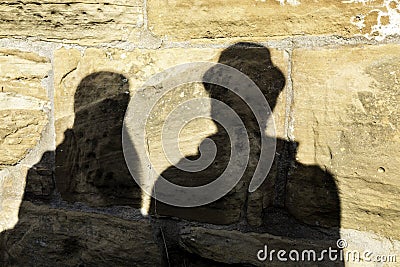Shadows of a pair of lovers on the big rocks of a medieval castle Stock Photo