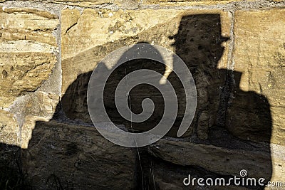 Shadows of a pair of lovers on the big rocks of a medieval castle Stock Photo