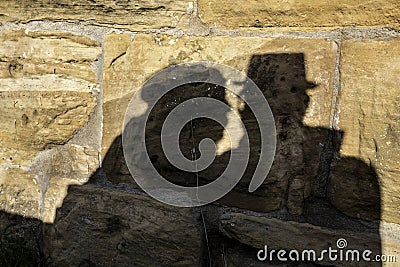 Shadows of a pair of lovers on the big rocks of a medieval castle Stock Photo