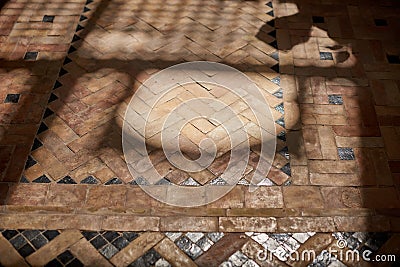 Shadows on the traditional Morrocan stone mosaic floor inside the Riad. Stock Photo