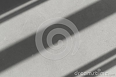 Shadows of window lines on a concrete stone wall in a bright room background. Abstract, geometry, light concept Stock Photo