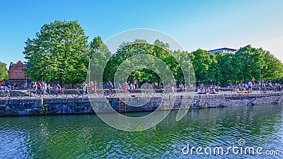 Shadwell Basin on a hot day with lots of people enjoying the sun Editorial Stock Photo