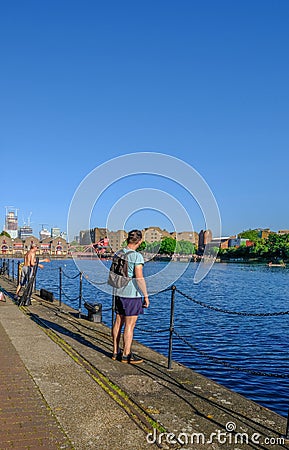 Vertical view of Shadwell Basin with man in the foreground Editorial Stock Photo