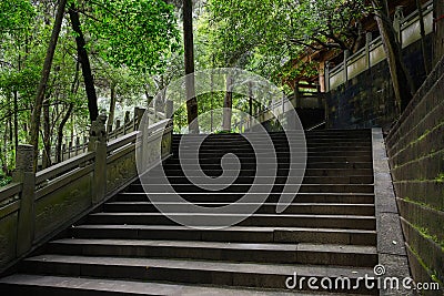 Shady hillside stone steps with balustrade before ancient Chines Stock Photo