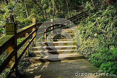 Shady planked stairway on mountainside in sunny winter Stock Photo