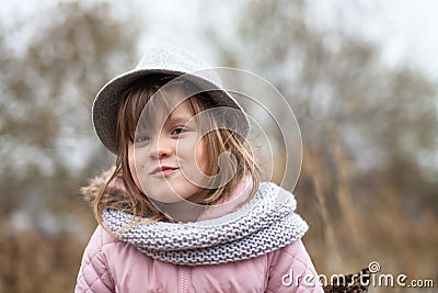 Shaggy girl in jacket, gray scarf and fedora hat Stock Photo