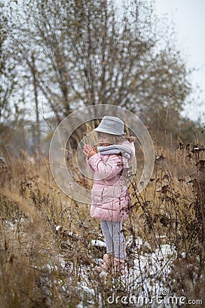 Shaggy girl in jacket, gray scarf and fedora hat Stock Photo