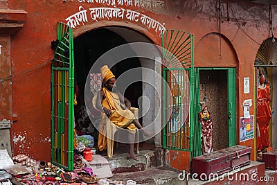 Shaiva sadhu seeking alms on the banks of Ganges river Editorial Stock Photo