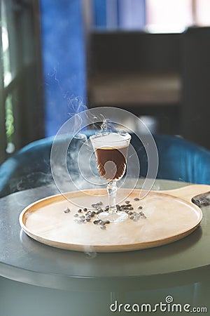 Shaken almond coffee with a blast of rosemary. Stock Photo