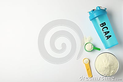 Shaker with abbreviation BCAA Branched-chain amino acid and powder on white, flat lay. Space for text Stock Photo