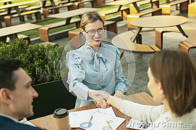 Happy joyful lady smiling when shaking hands Stock Photo