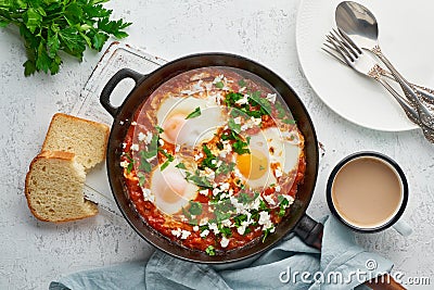 Shakshouka, eggs poached in sauce of tomatoes, olive oil. Mediterranean cousine Stock Photo