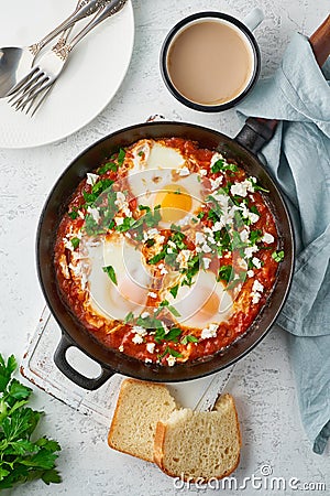 Shakshouka, eggs poached in sauce of tomatoes, olive oil. Mediterranean cousine Stock Photo