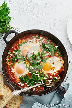 Shakshouka, eggs poached in sauce of tomatoes, olive oil. Mediterranean cousine Stock Photo