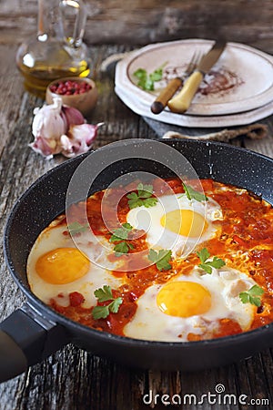 Shakshouka: fried eggs with tomatoes and peppers Stock Photo