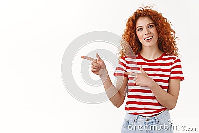 Shall we. Enthusiastic attractive redhead curly woman look curious pointing left index finger smiling happy excited Stock Photo