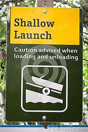 A shallow boat launch sign advising caution Stock Photo